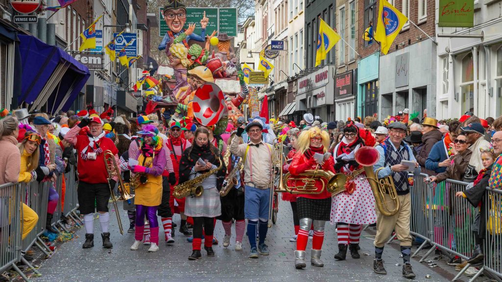 Mensen die carnaval vieren in de straten van Breda.